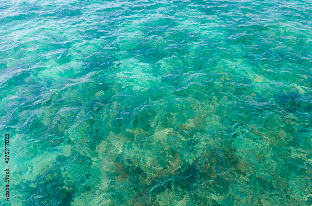 closeup beautiful clear blue sea water on the beach paradise ocean. vacation background on summer in Thailand coast.