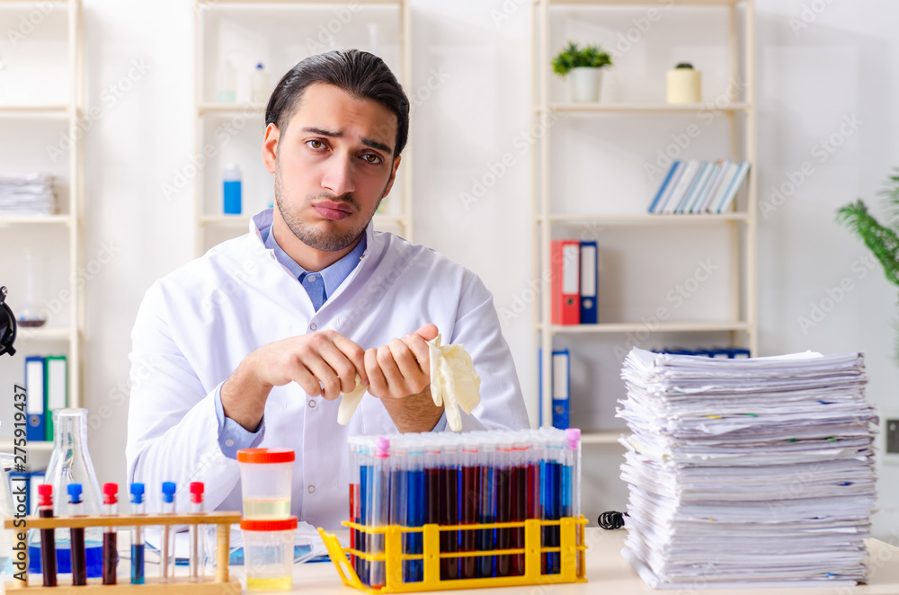 Young male chemist working in the lab Young male chemist working in the lab