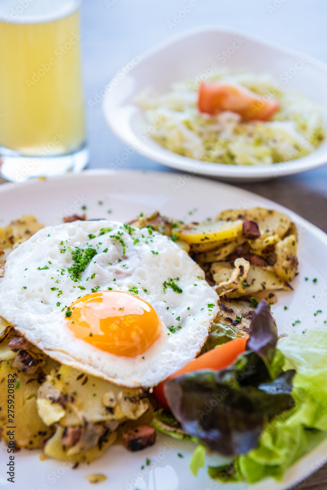 fried egg with fried potatoes, ham, cabbage salad and beer fried egg with fried potatoes, ham, cabbage salad and beer
