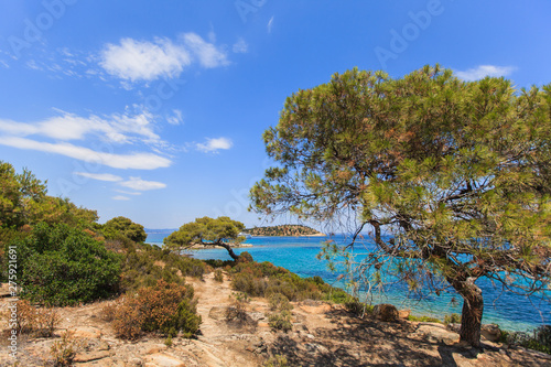 Wonderful summer seascape of turquoise sea water and yacht at coast Sithonia on Halkidiki Greece