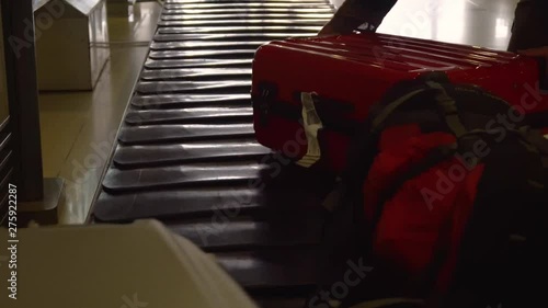 Luggage goes on a conveyor carousel at the airport. the man takes his things from the excalator. photo