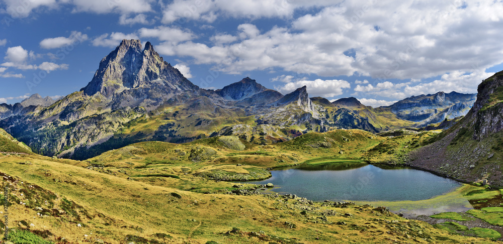 Panoramic view at Midi Ossau mountain peak and Lake Miey, in  Ayous-Bious valley in French Atlantic Pyrenees, as seen in October. Aquitaine, France.