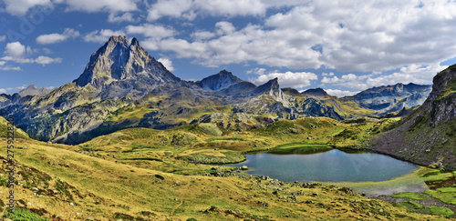 Panoramic view at Midi Ossau mountain peak and Lake Miey, in Ayous-Bious valley in French Atlantic Pyrenees, as seen in October. Aquitaine, France.