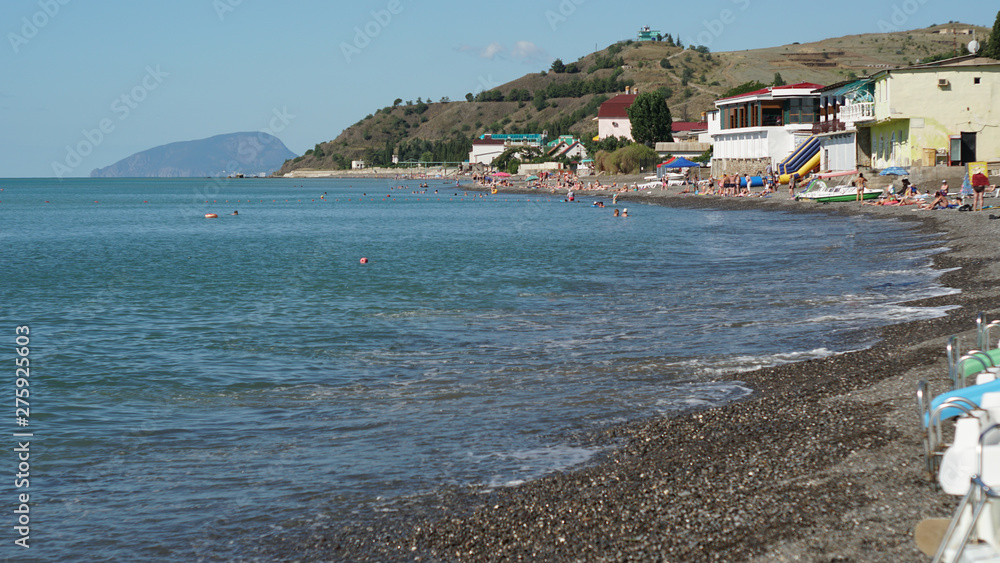 Sea beach in the bay and summer time in the Crimea