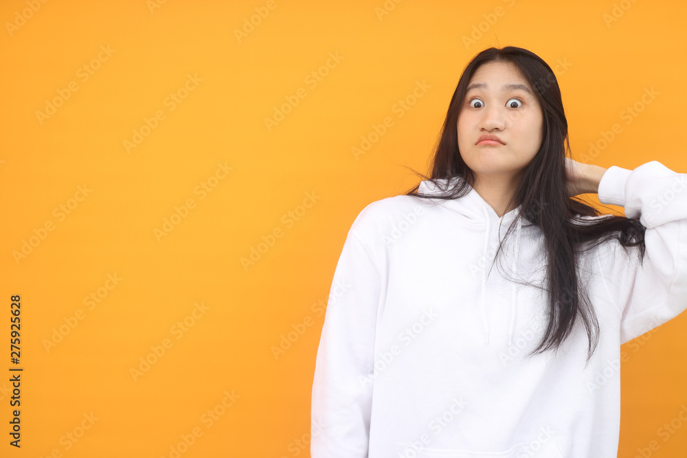 Isolated shot of pretty Beautiful Asian models over pink background for advertising concept , wears casual outfit, being entertained by friend during party Isolated shot of pretty Beautiful Asian models over pink background for advertising concept , wears casual outfit, being entertained by friend during party