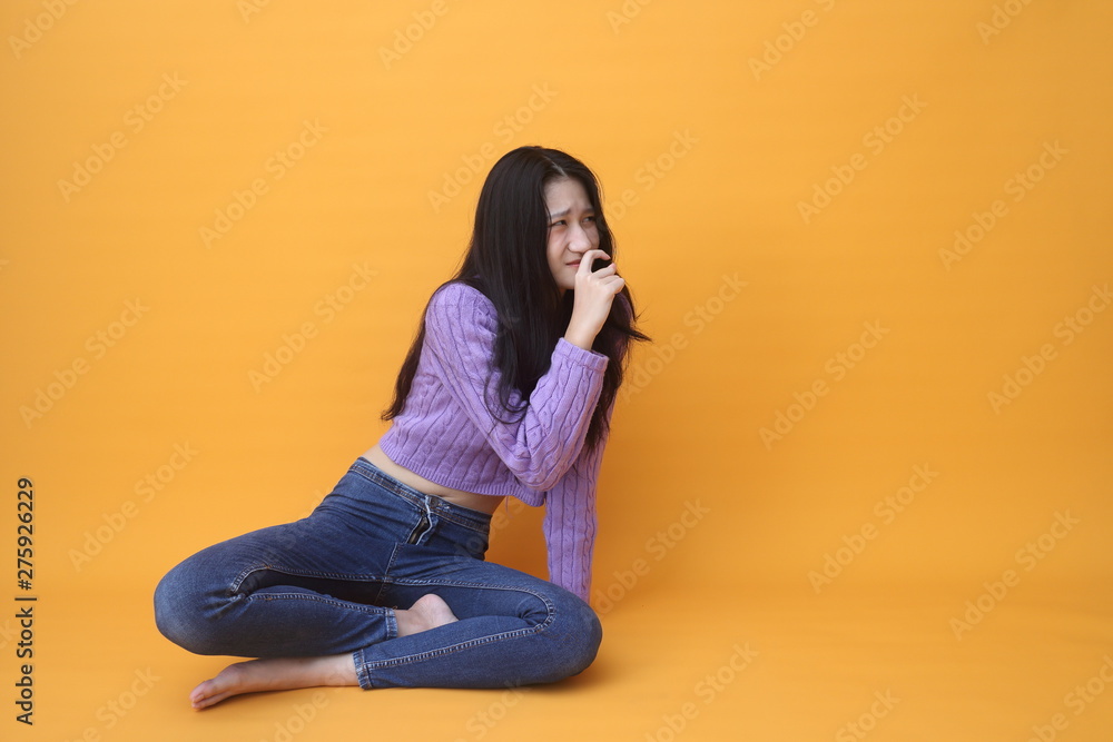Isolated shot of pretty Beautiful Asian models over pink background for advertising concept , wears casual outfit, being entertained by friend during party Isolated shot of pretty Beautiful Asian models over pink background for advertising concept , wears casual outfit, being entertained by friend during party