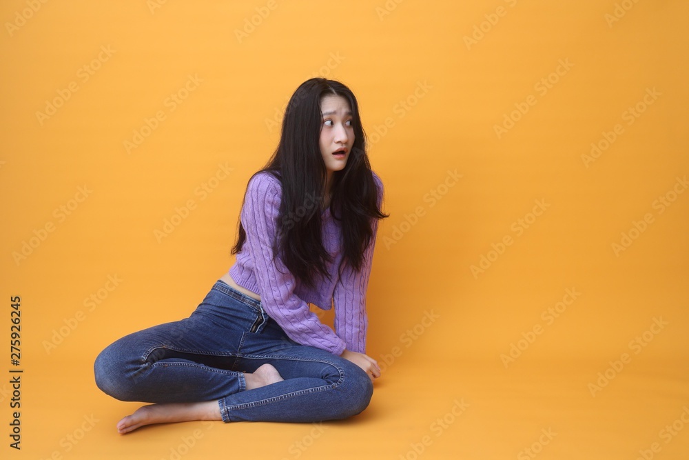Isolated shot of pretty Beautiful Asian models over pink background for advertising concept , wears casual outfit, being entertained by friend during party Isolated shot of pretty Beautiful Asian models over pink background for advertising concept , wears casual outfit, being entertained by friend during party