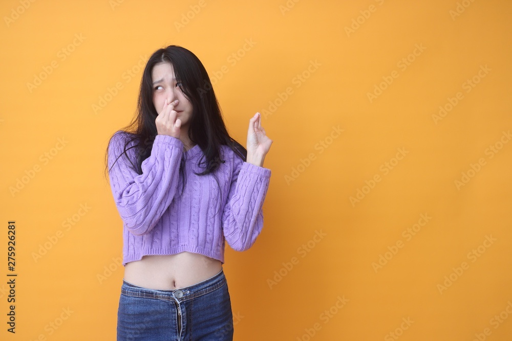 Isolated shot of pretty Beautiful Asian models over pink background for advertising concept , wears casual outfit, being entertained by friend during party Isolated shot of pretty Beautiful Asian models over pink background for advertising concept , wears casual outfit, being entertained by friend during party