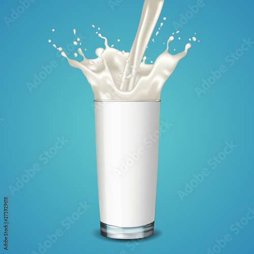 Pouring milk into glass, isolated on blue background.