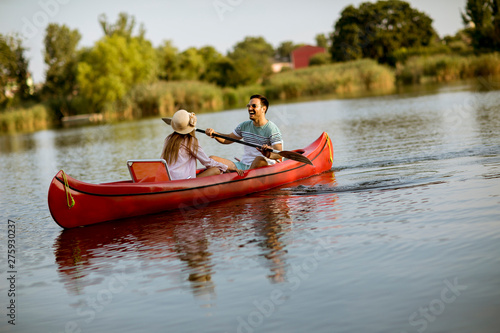 Loving couple rowing on the lake