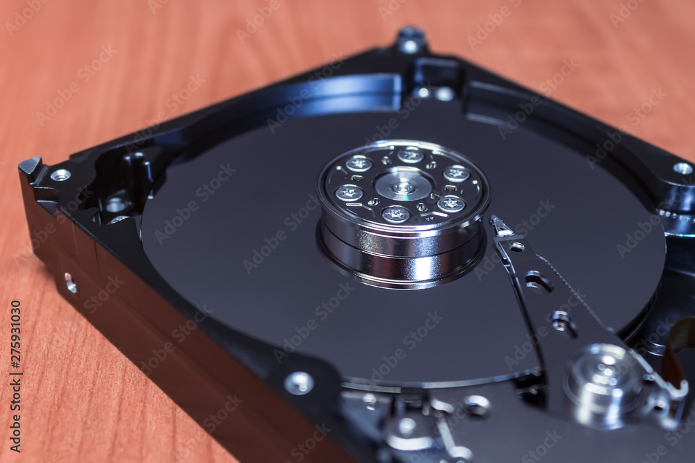 Computer hard drive without a cover, the mirror surface of the disk and parts Computer hard drive without a cover, the mirror surface of the disk and parts
