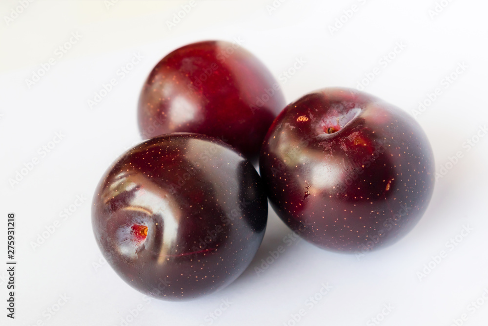 close up of red cherry plums isolated close up of red cherry plums isolated