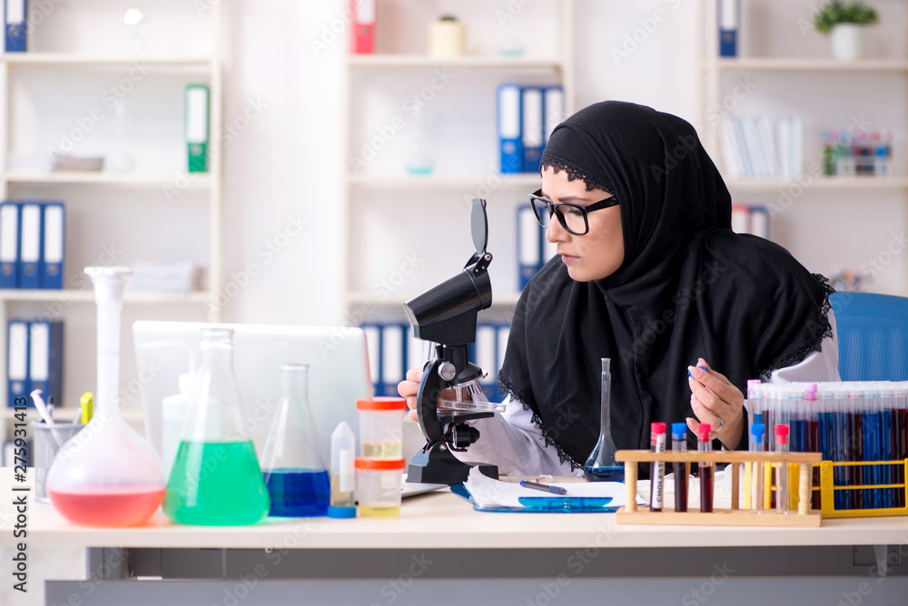 Female chemist in hijab working in the lab Female chemist in hijab working in the lab
