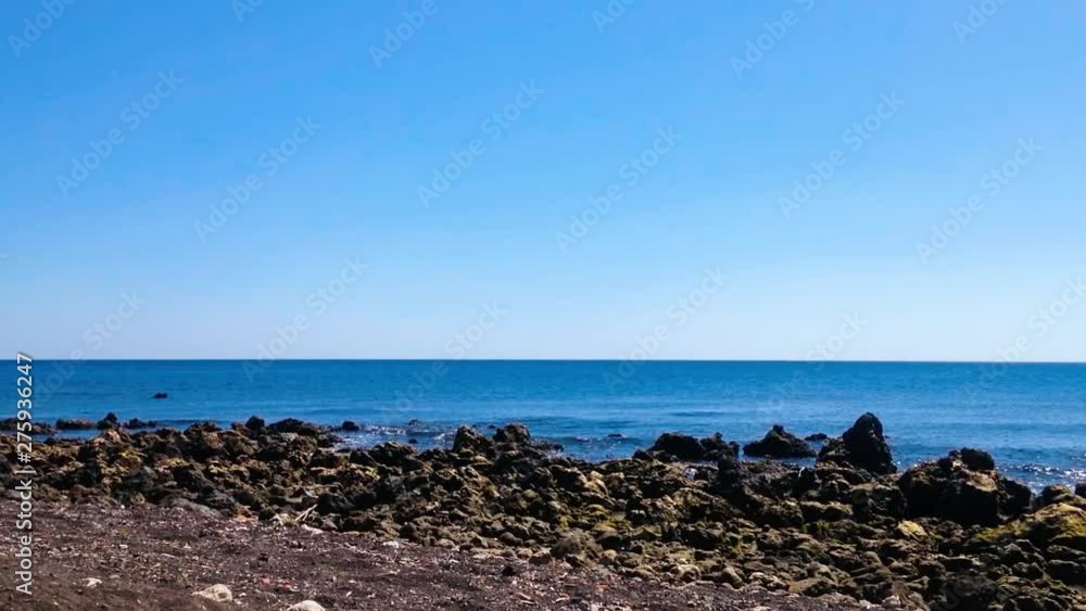 Natural Beach Atmosphere With Sand And Rocky Beach Scenery In The Clear Blue Sky On A Sunny Day At Umeanyar Village, North Bali, Indonesia Natural Beach Atmosphere With Sand And Rocky Beach Scenery In The Clear Blue Sky On A Sunny Day At Umeanyar Village, North Bali, Indonesia