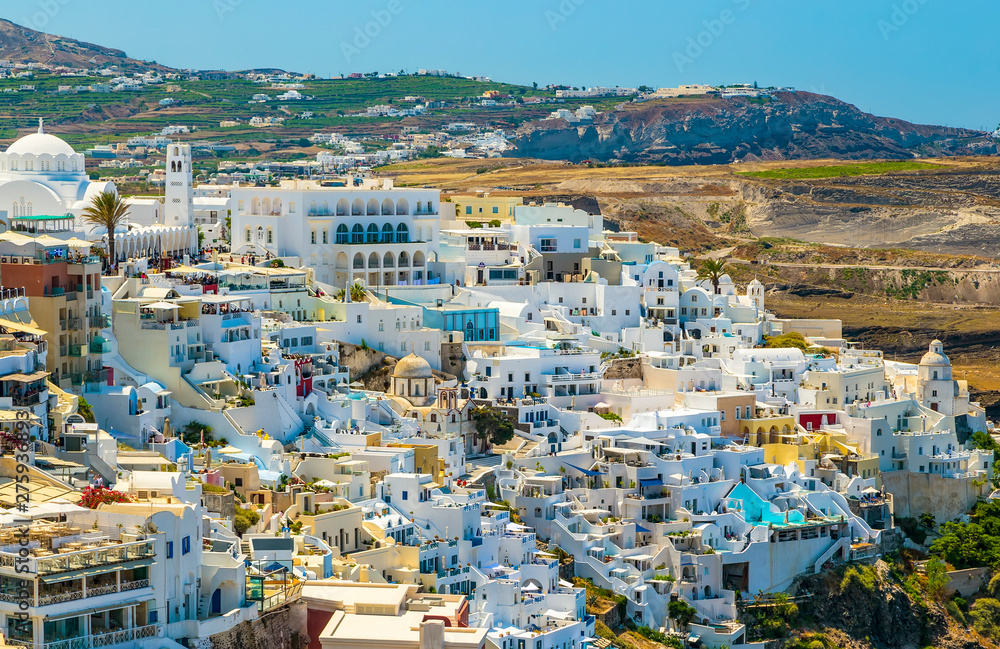top view of Fira city architecture, mountains and buildings in background of Santorini, Greece