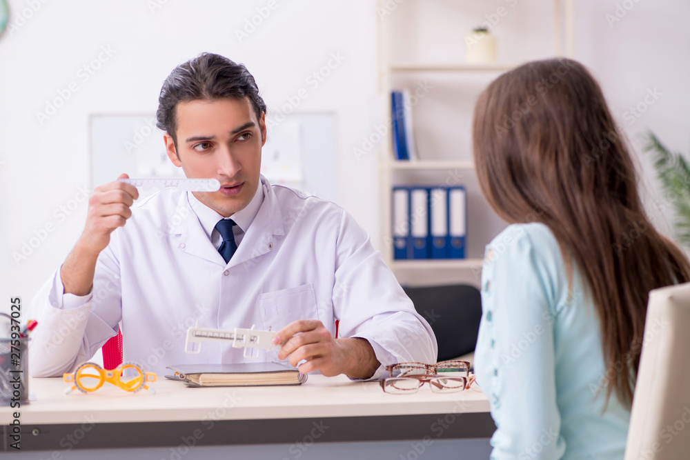 Young woman visiting male doctor oculist Young woman visiting male doctor oculist