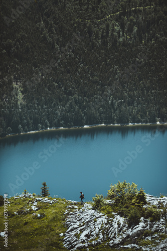 A male hiker walking along a rocky ridge abve Altaussee Lake in Tirol, Austria photo