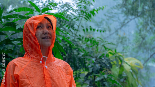 Woman wearing orange raincoat out in the rain