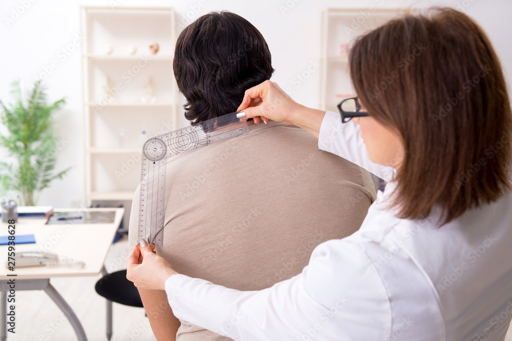 Female doctor checking patient's joint flexibility with goniometer Female doctor checking patient's joint flexibility with goniometer