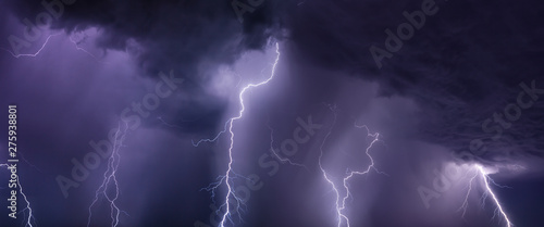 Huge lightnings and heavy rain in dark stormy sky