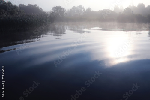 Fog in the lake. Morning nature water white fog. © alexkich