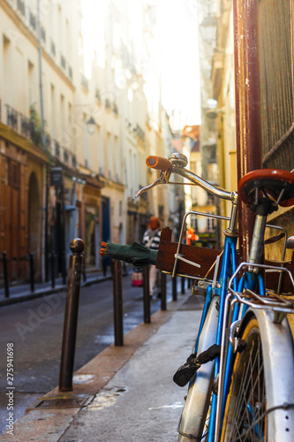 Blue classic vintage bicycle in street in Paris. It is showing the European green and healthy lifestyle and city life
