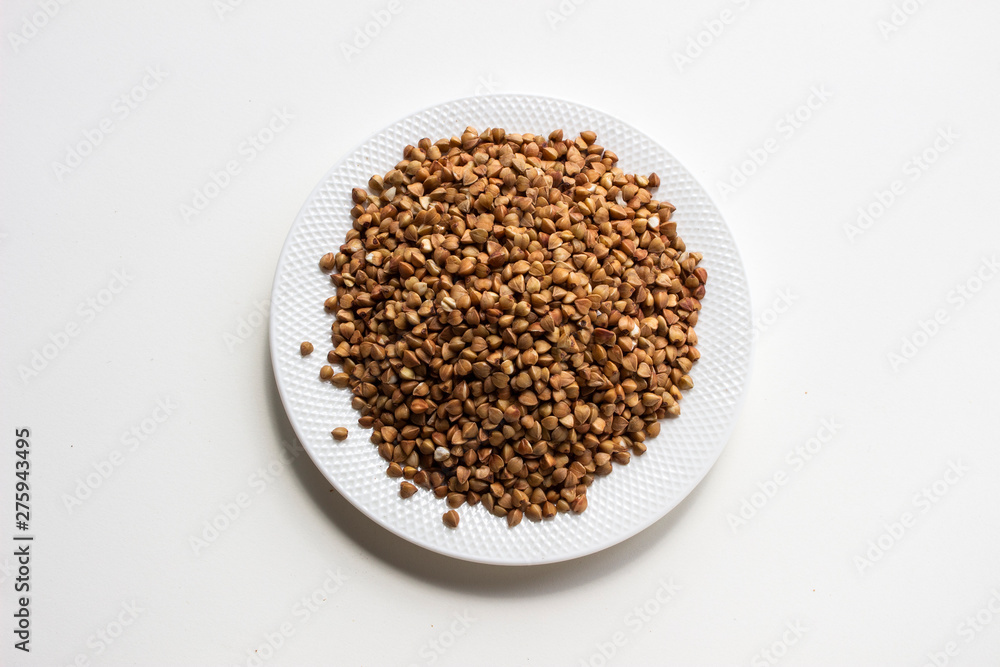 buckwheat in bowl isolated on white buckwheat in bowl isolated on white