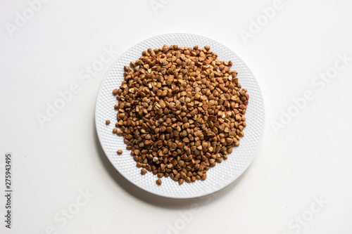 buckwheat in bowl isolated on white