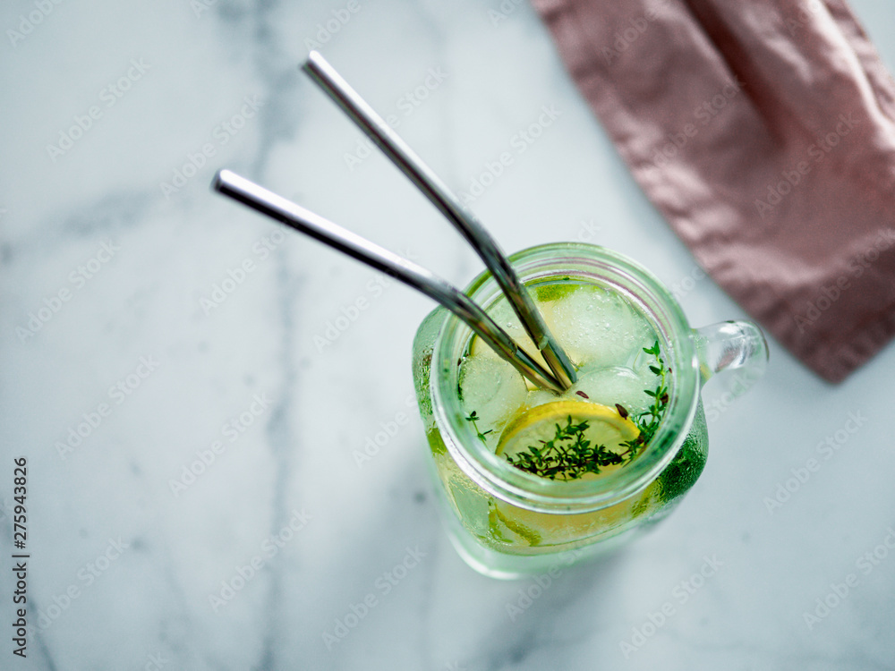 Metal drinking straws and cold drink in glass mason jar on white marble background. Top view or flat lay. Copy space for text or design. Recyclable straws, zero waste concept. Banner. Metal drinking straws and cold drink in glass mason jar on white marble background. Top view or flat lay. Copy space for text or design. Recyclable straws, zero waste concept. Banner.
