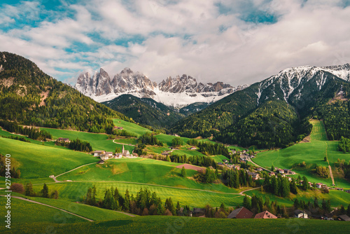 Famous alpine Santa Maddalena village with Dolomites mountains in background, Val di Funes valley