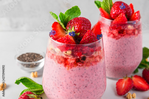 strawberry yogurt with chia seeds, fresh berries, granola and mint for healthy tasty breakfast