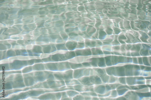 blue water ripples in a summer swimming pool