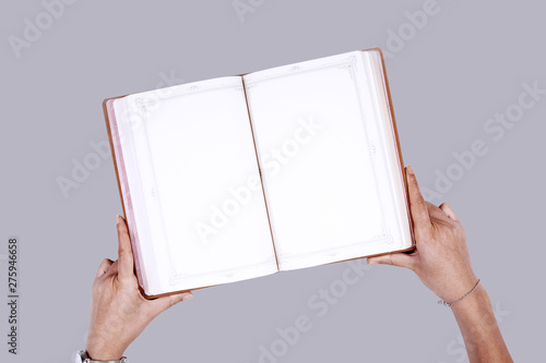 Woman holding brochure with blank cover on wooden background, top view.  © izzetugutmen