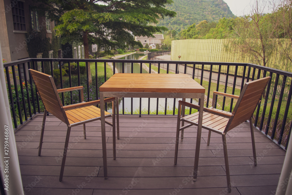 Wooden table and chair set on the balcony of the house