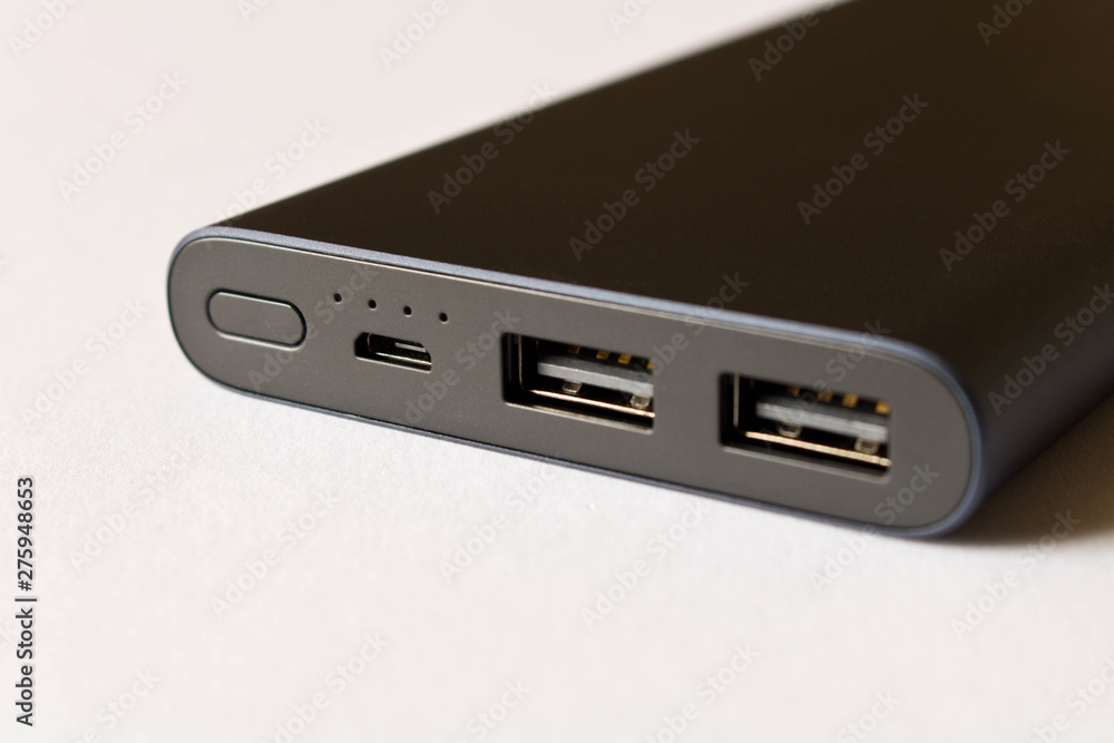 Black power Bank for charging mobile devices on a white background. Black power Bank for charging mobile devices on a white background.