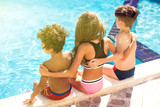 Children with sun protection cream on skin in the pool. Children, summer, holiday and healthcare concept
