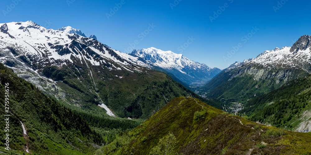 the mont blanc massif and the aguille du midi in the french alpine valley of chamonix showing clear blue skies and snow capped peaks during spring the mont blanc massif and the aguille du midi in the french alpine valley of chamonix showing clear blue skies and snow capped peaks during spring