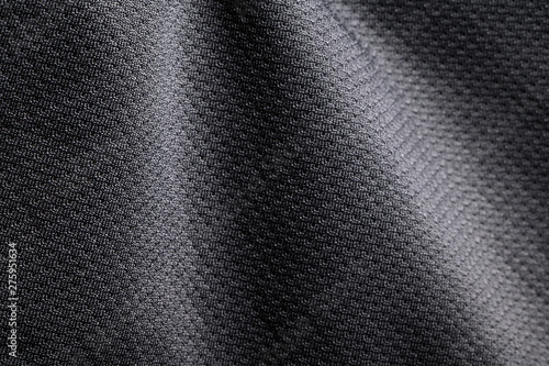 Close-up polyester fabric texture of black athletic shirt