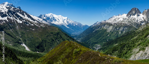 the mont blanc massif and the aguille du midi in the french alpine valley of chamonix showing clear blue skies and snow capped peaks during spring