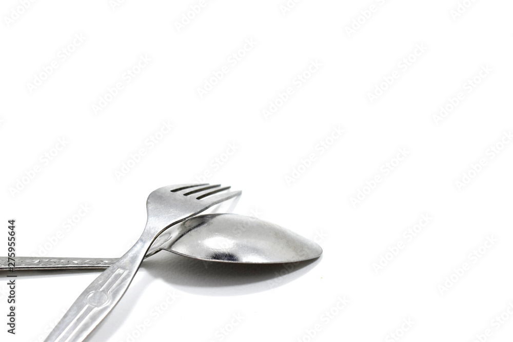 Spoon and fork placed together Spoon and fork placed together