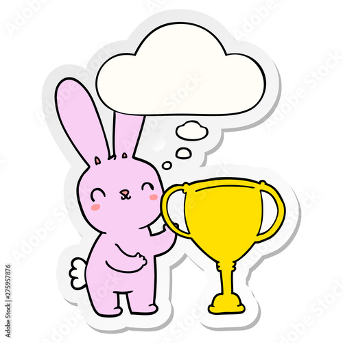 cute cartoon rabbit with sports trophy cup and thought bubble as a printed sticker