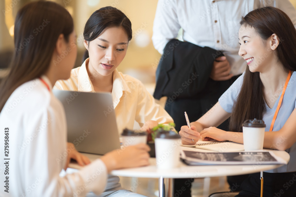 Young Asian woman and business people are meeting in office discussion with colleagues . Group of Business team working and share ideas about project to partners Young Asian woman and business people are meeting in office discussion with colleagues . Group of Business team working and share ideas about project to partners