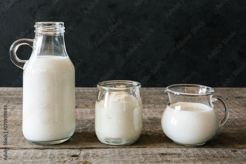 Dairy cuisine. Fresh milk and healthy yogurt on wooden table. Dairy cuisine. Fresh milk and healthy yogurt on wooden table.