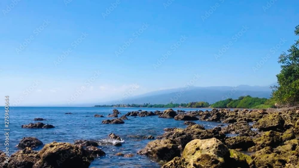 Motion Tropical Beach With Large Number Chunk Of Sea Rocks In Dry Season On A Sunny Day At The Village, Umeanyar, North Bali, Indonesia Motion Tropical Beach With Large Number Chunk Of Sea Rocks In Dry Season On A Sunny Day At The Village, Umeanyar, North Bali, Indonesia