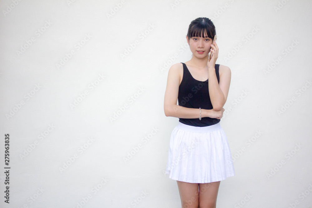 Portrait of thai adult beautiful girl black shirt white skirt calling smart phone Portrait of thai adult beautiful girl black shirt white skirt calling smart phone