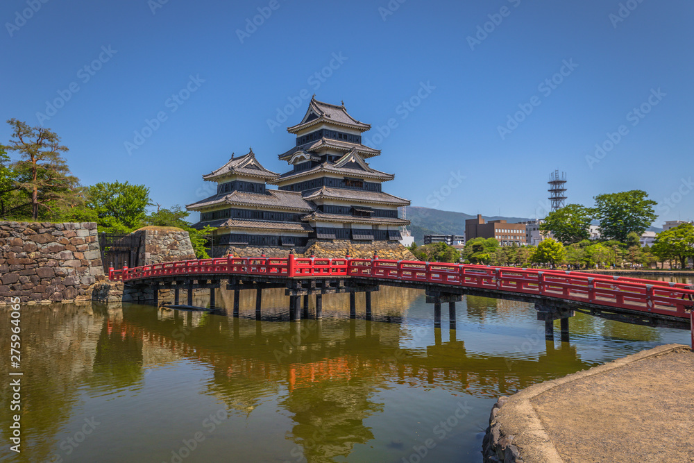 Matsumoto - May 25, 2019: The castle of Matsumoto and the red bridge leading to it, Japan Matsumoto - May 25, 2019: The castle of Matsumoto and the red bridge leading to it, Japan