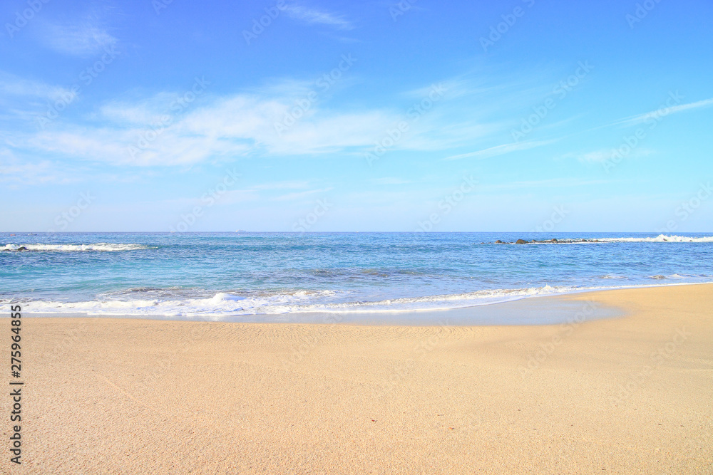 waves on the water of a sandy summer beach