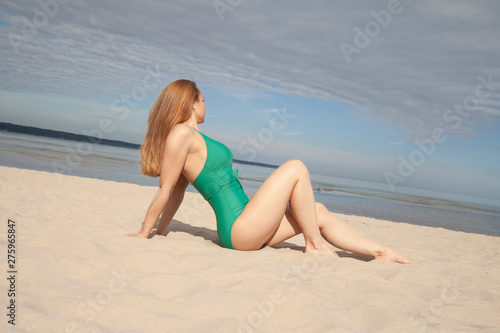 girl in a green bathing suit on the beach