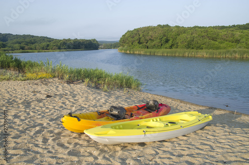 Two types of kayak two-seat sit-on-top on the sandy bank of the river Veleka, Bulgaria