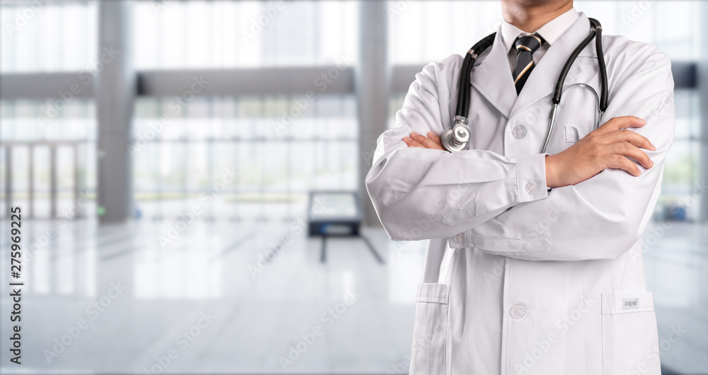 young doctor with hospital background